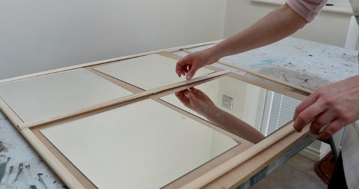 Spiegelfolie wordt op een meubelpaneel aangebracht